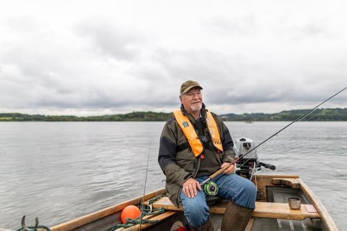 Man out in a fishing boat on the lake