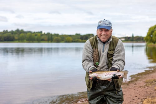 Man showing a fish he has just caught